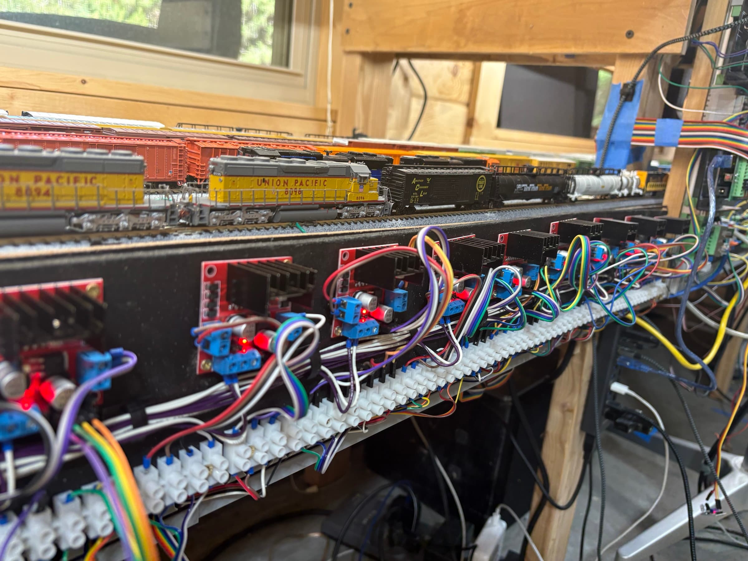 Driver boards mounted below the fascia, with trains on the layout above